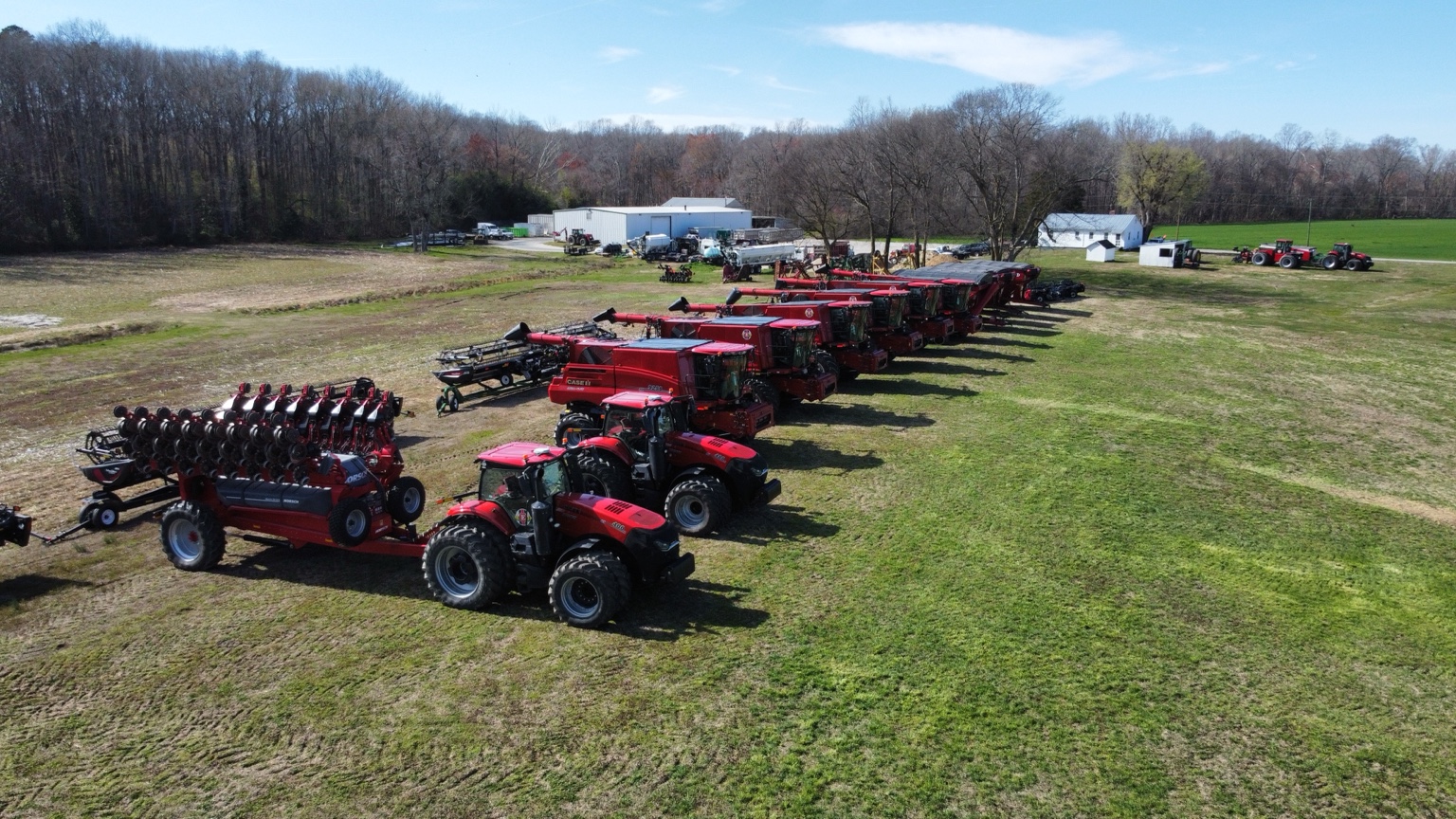 Tractors, combines, and grain carts lined up together